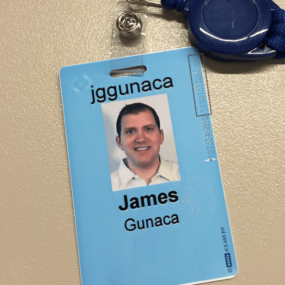 A badge with a photo of James Gunaca