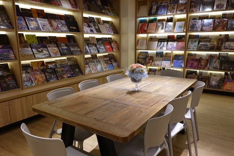 A reading room with a large table and shelves.