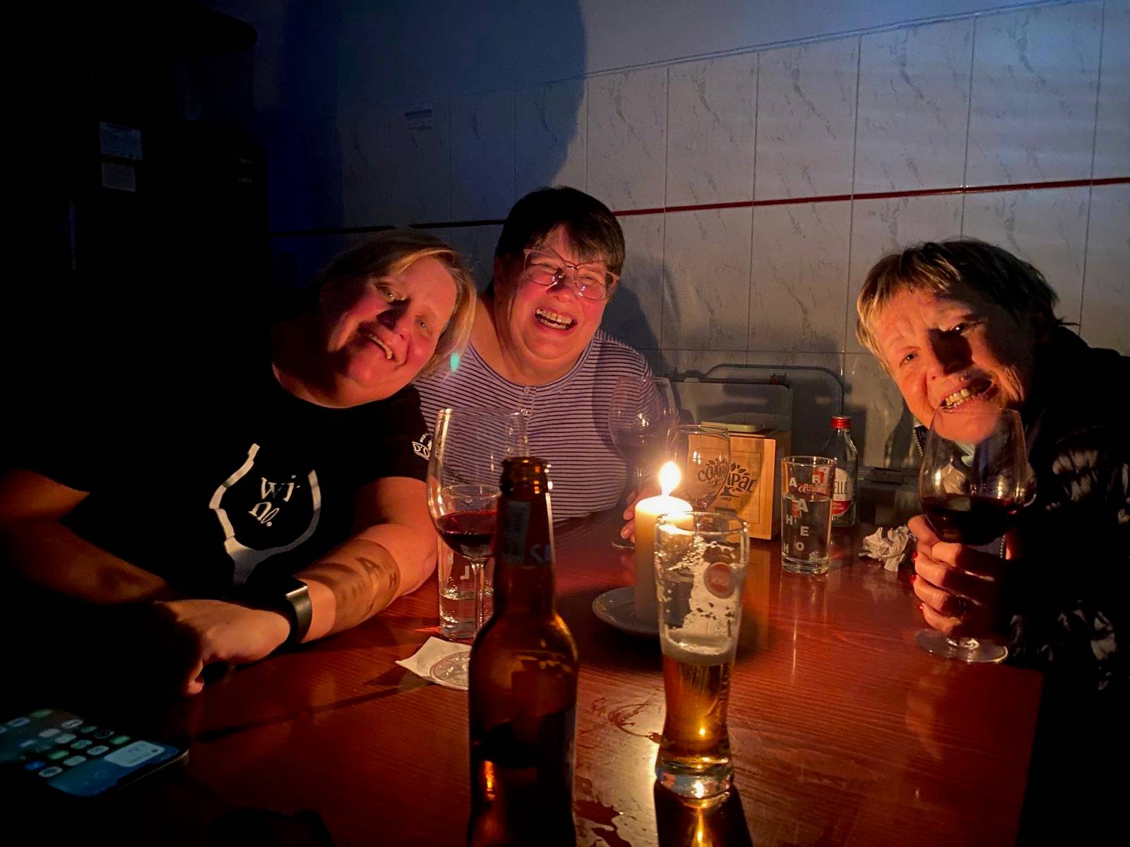 Three friends sitting by candle light at the local cafe