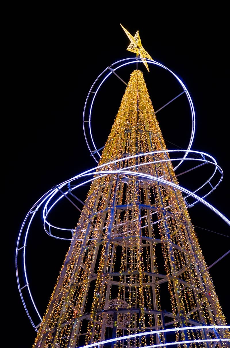 A lit christmas tree with a star on top