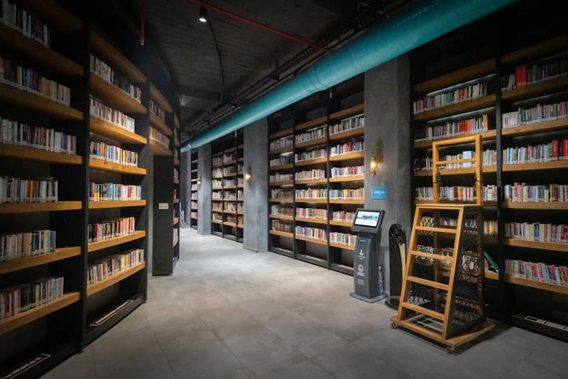 A library filled with lots of books and a phone