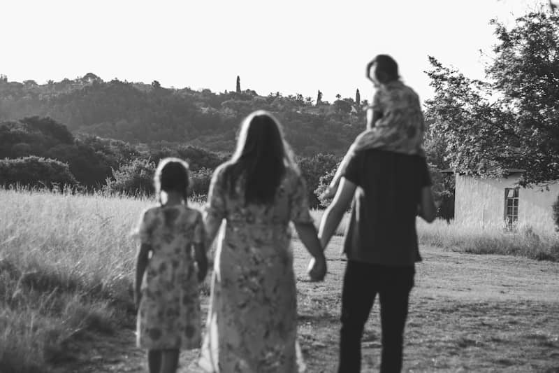 A family walks together into the sunset.