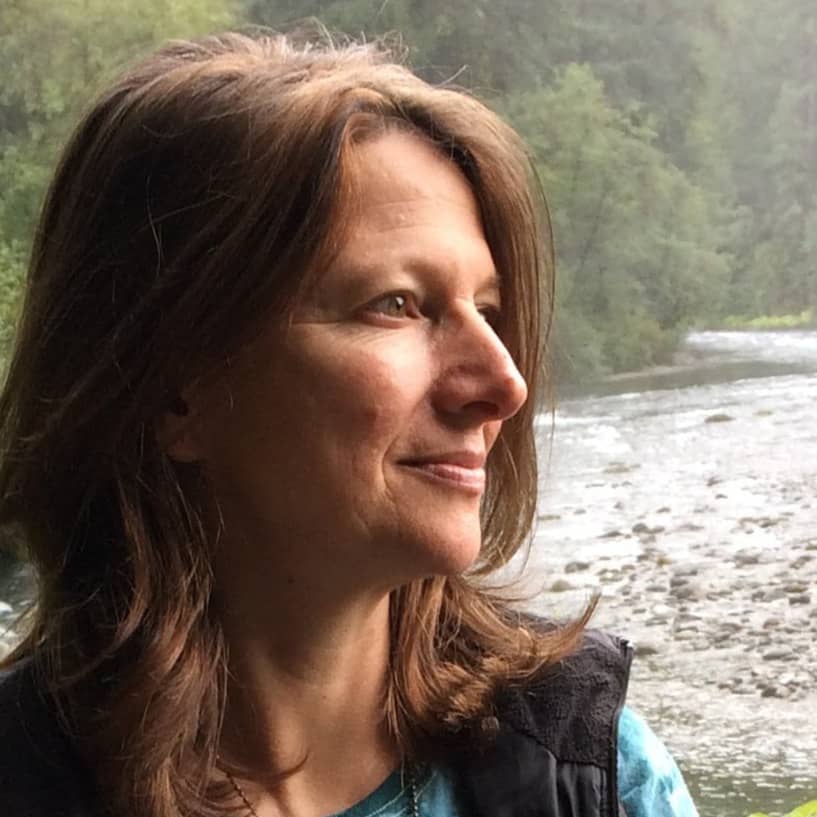 Woman near a river with sun on face