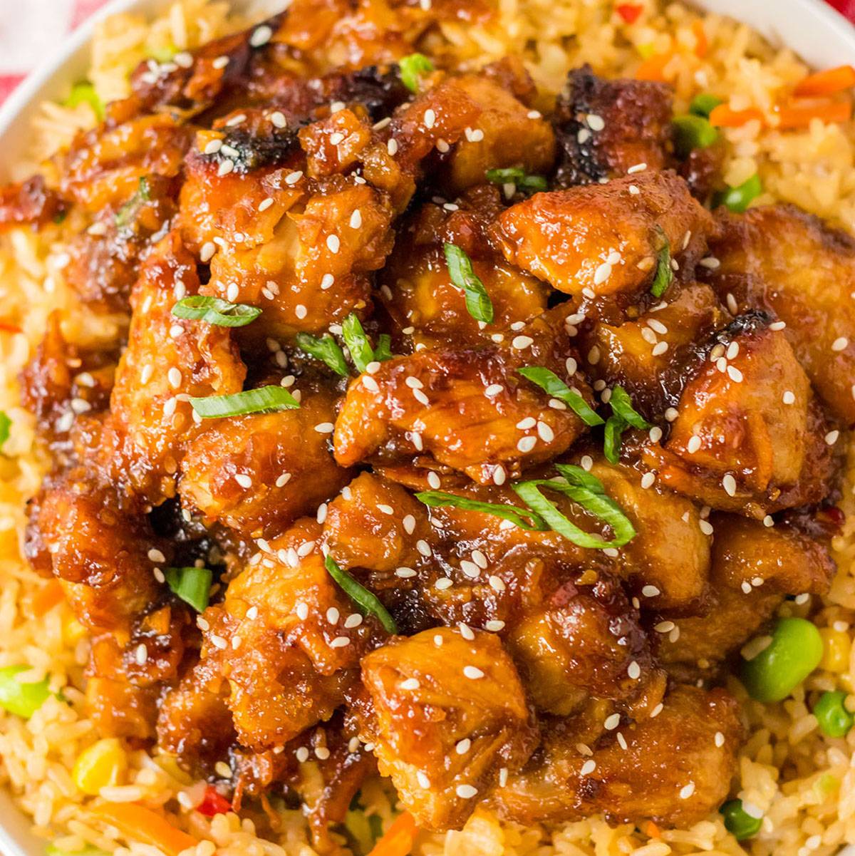 overhead shot of orange chicken over fried rice.