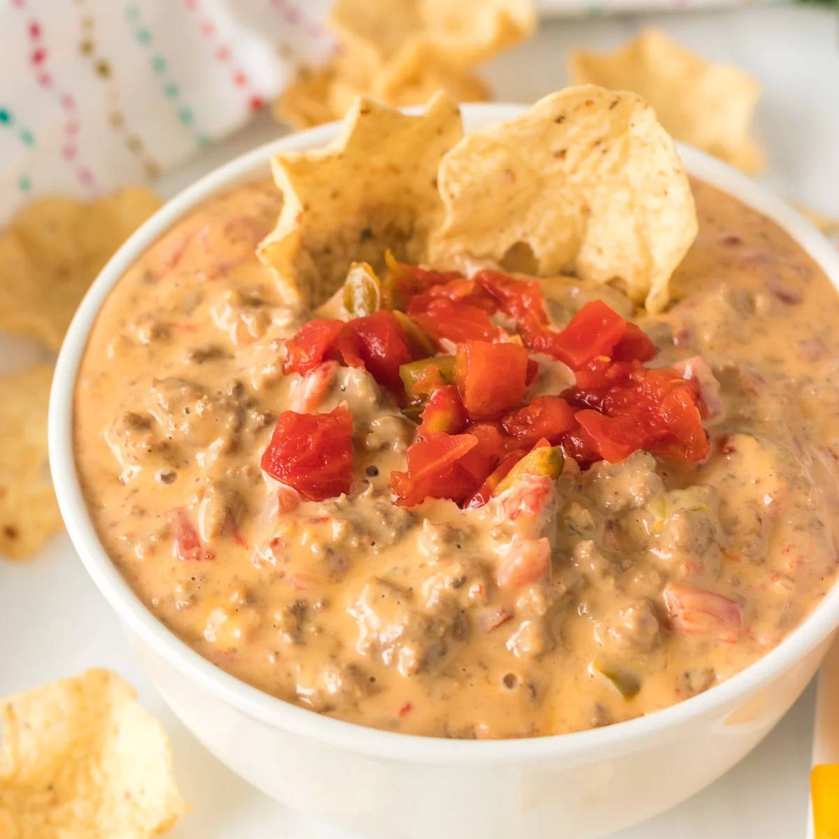 bowl of cheese dip with tortilla chips.