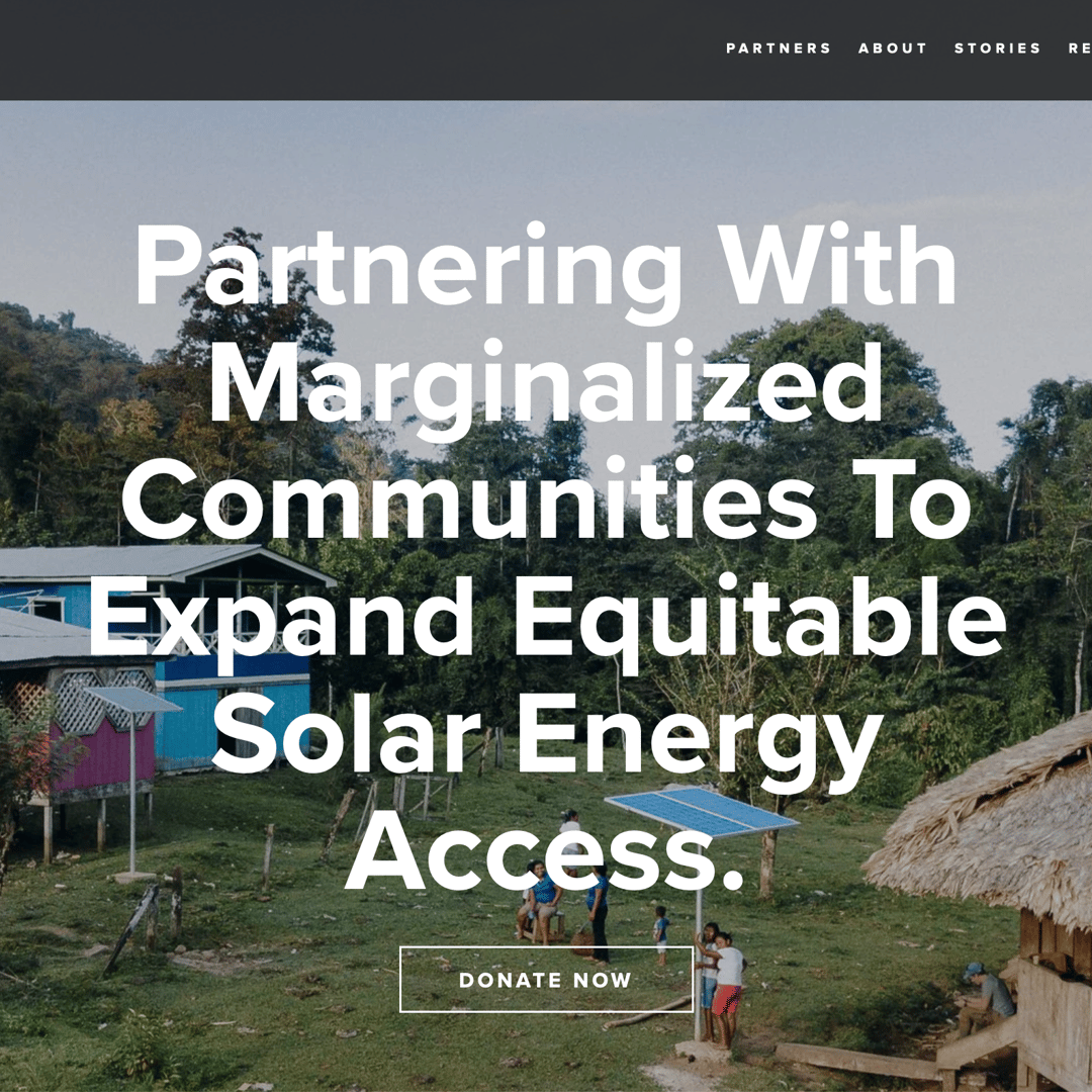 Screenshot of a page on the Honnold Foundation's website. A photo of a rural rainforest community shows a field surrounded by small buildings - a two-story bright blue building with solar panels, a smaller pink building on stilts with solar panels, and a thatched building on stilts in the foreground with a solar panel on a pole in front of it - and by forested mountains beyond. Several people are visible, including young children. The overlaid white text reads: "Partnering With Marginalized Communities To Expand Equitable Solar Energy Access." A button below the text reads "DONATE NOW".