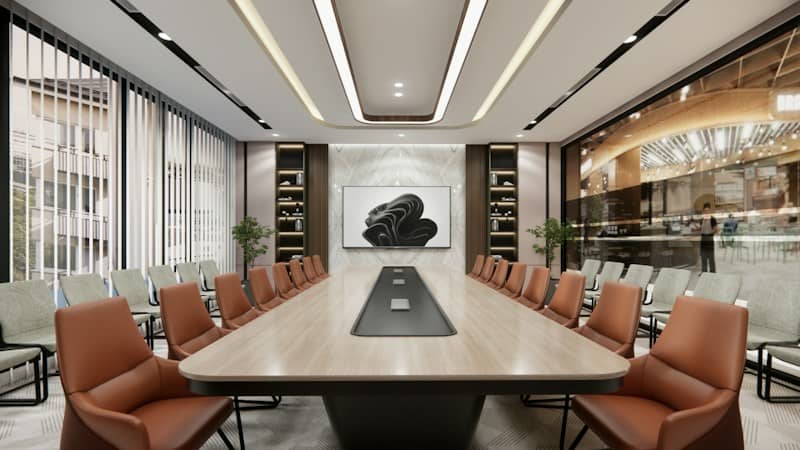 A long conference table with orange chairs in a modern office meeting room