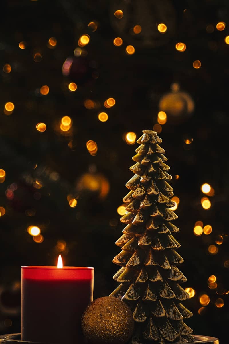 Red candle and christmas tree decoration with bokeh lights