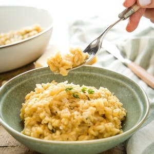 dish of risotto topped with fresh herbs  