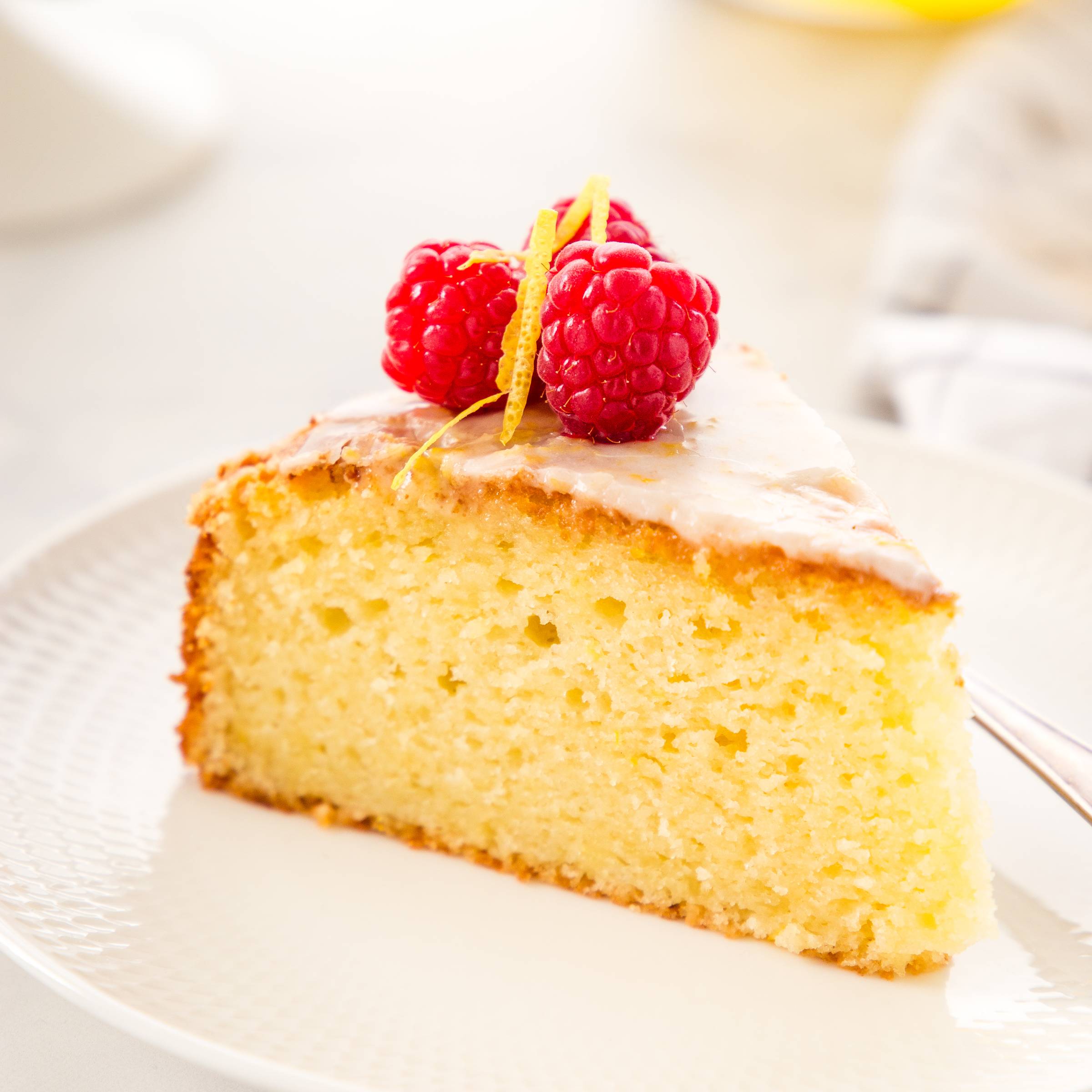 slice of olive oil cake with fresh raspberries on top