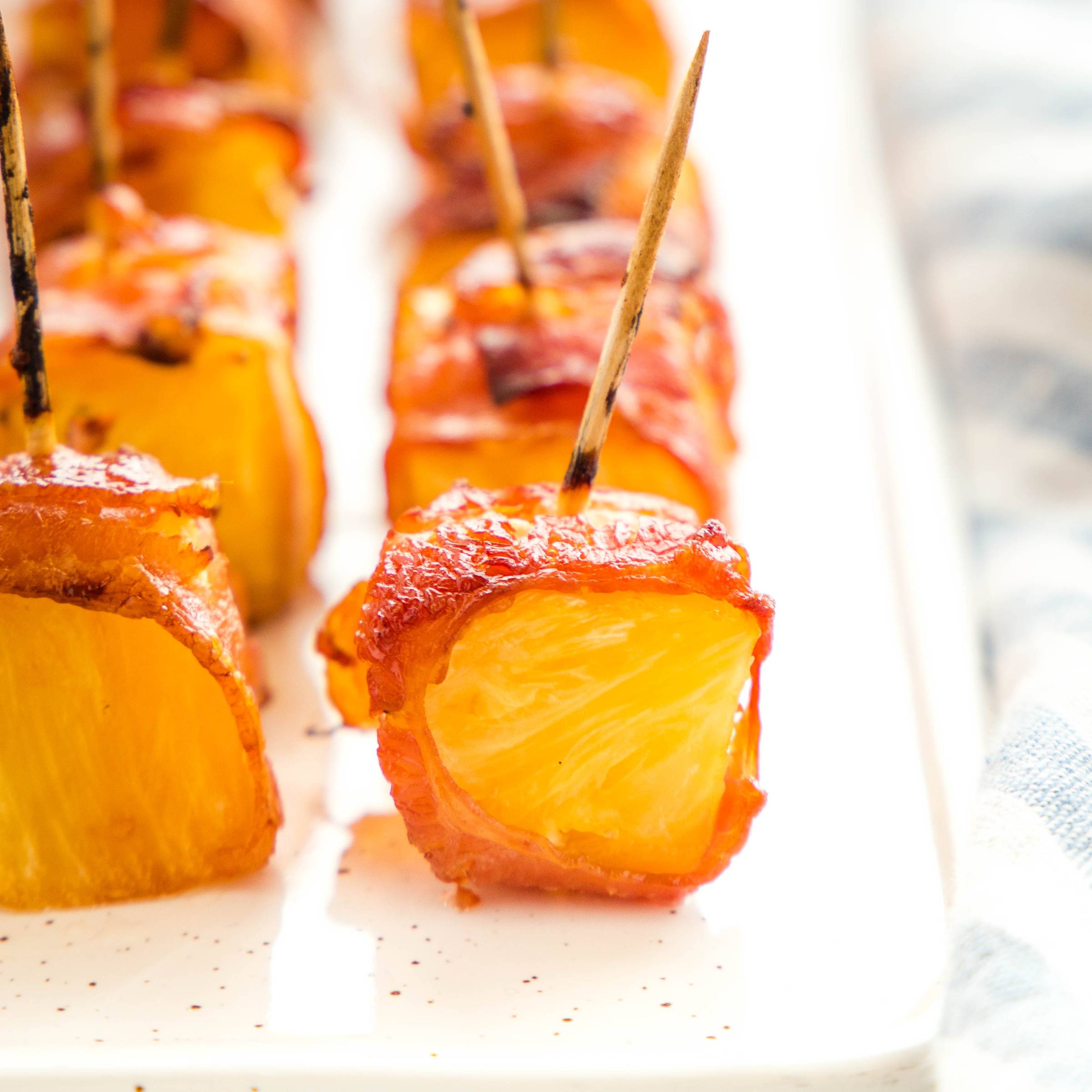 bacon wrapped pineapple on a platter