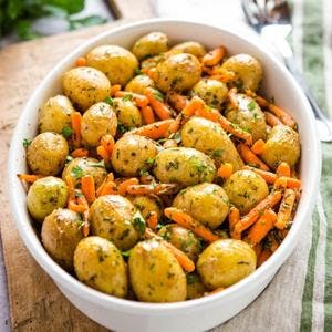 dish of roasted potatoes and carrots with fresh herbs