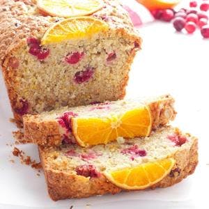 loaf of Cranberry Orange Oatmeal Bread, with pieces sliced off