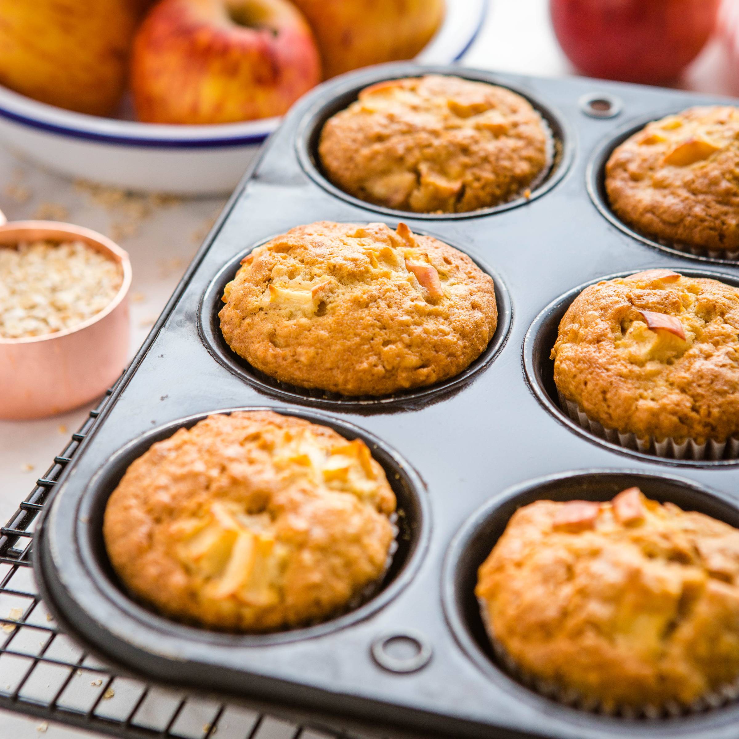 apple oat muffins cooling in a muffin tin