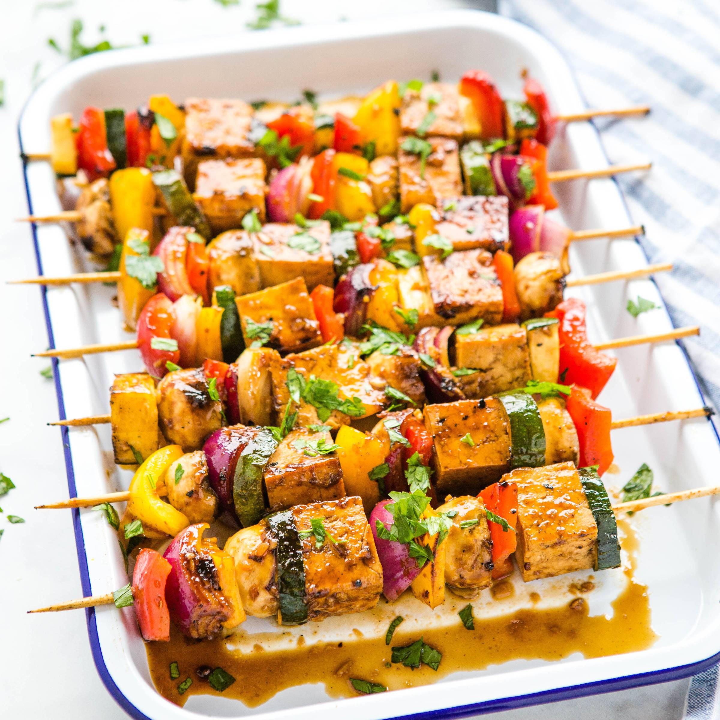 a platter of marinated tofu veggie skewers