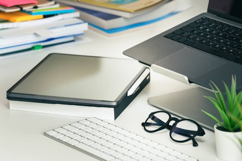 a laptop computer sitting on top of a white desk