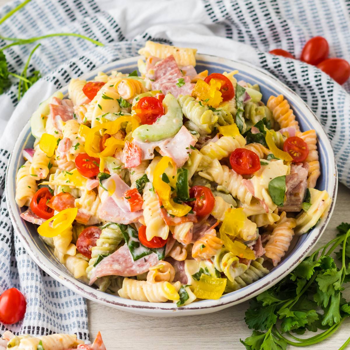 Bowl of pasta salad with italian sub meats, tomato, and peppers..