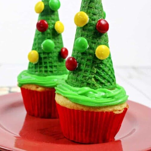 Ice cream cone topped cupcakes decorate to look like Christmas trees.