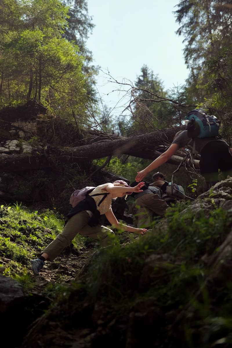 A person climbing up a hill with a backpack