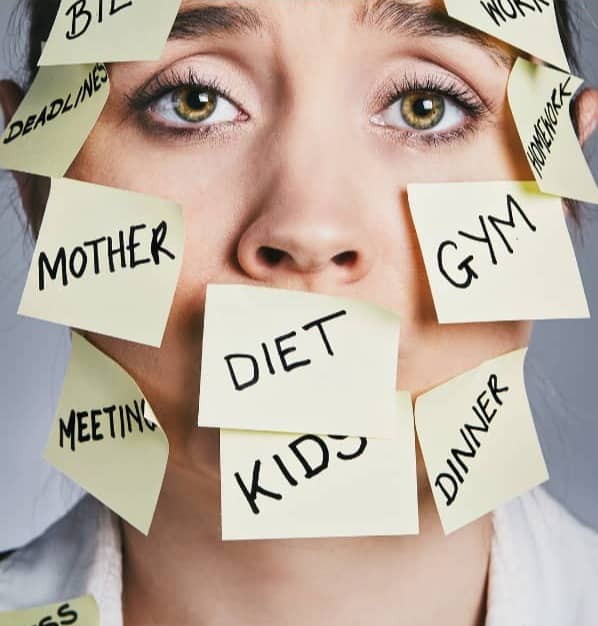 Woman with sticky notes all over her face with tasks written on them.