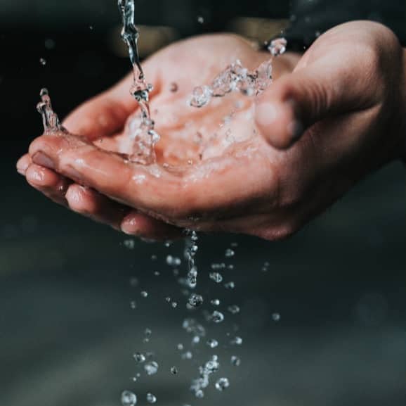 Water begin poured into someone's hands