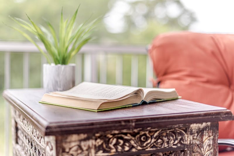 opened book on brown wooden table