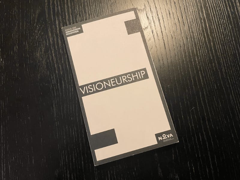 The "Visioneurship" handbook on a table.