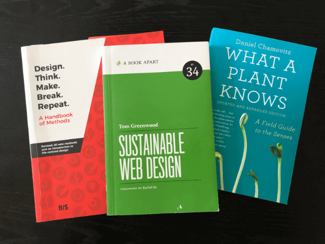 Three books (as described in the paragraphs) on a table
