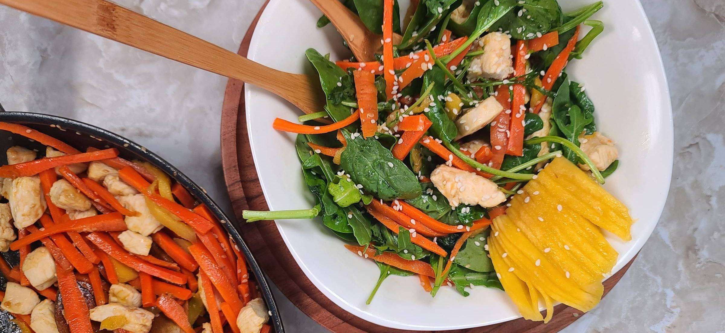 Honey sesame chicken salad served with a side of pasta