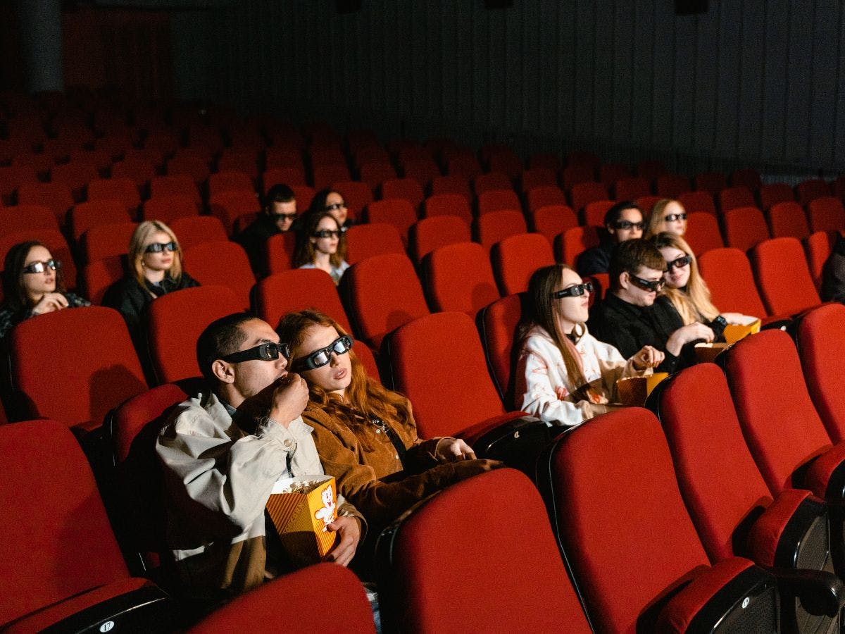 people in a theater watching a movi