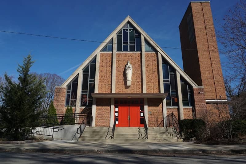 A modern brick church with a tall bell tower.