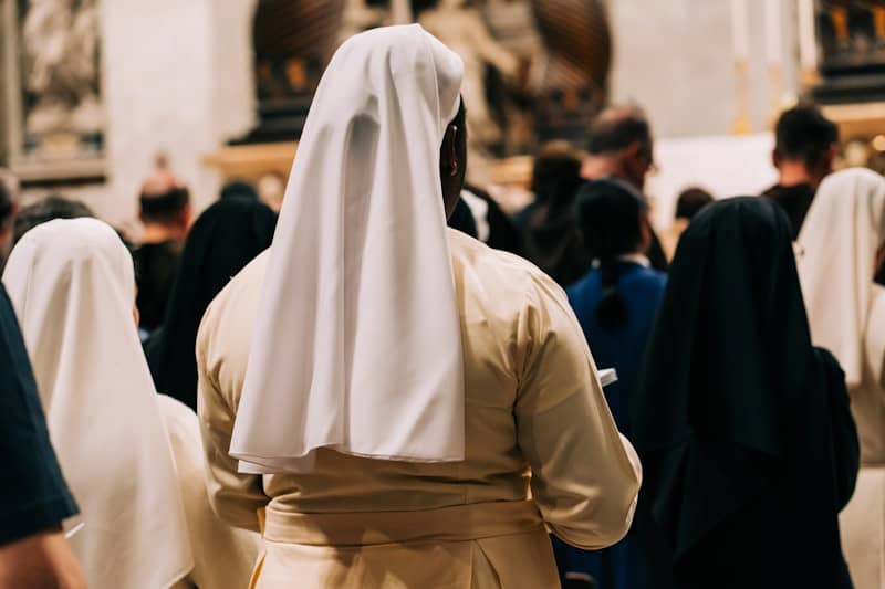 a group of people dressed in white and black