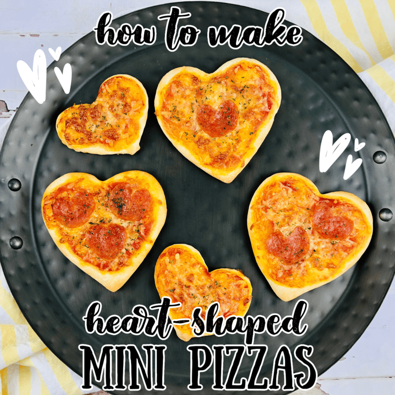 heart shaped pizzas on a black plate