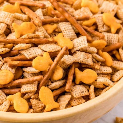 a close up of Chex Mix in a wooden bowl