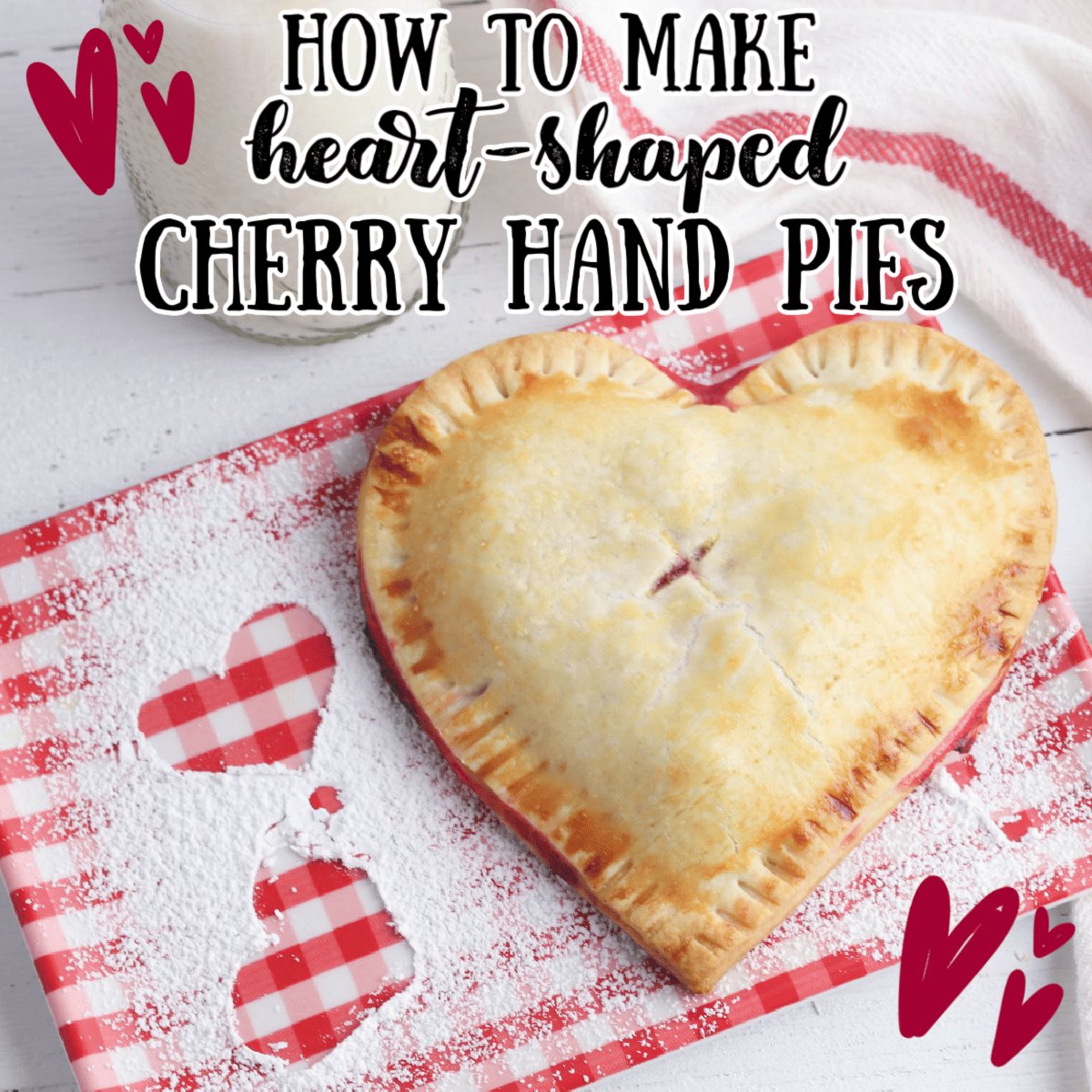 heart shaped cherry hand pies on a red gingham plate