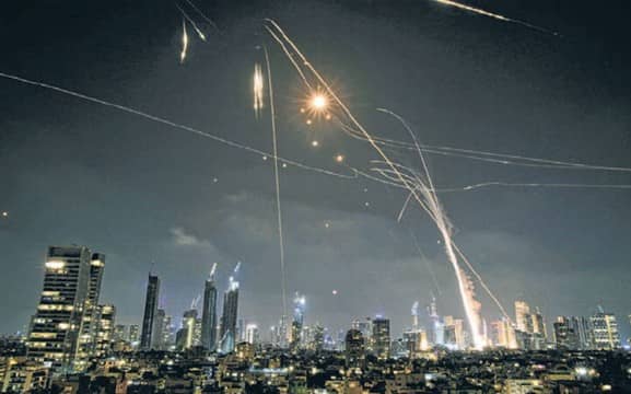 Israeli air defense systems fire to intercept missiles during an Iranian attack over Tel Aviv