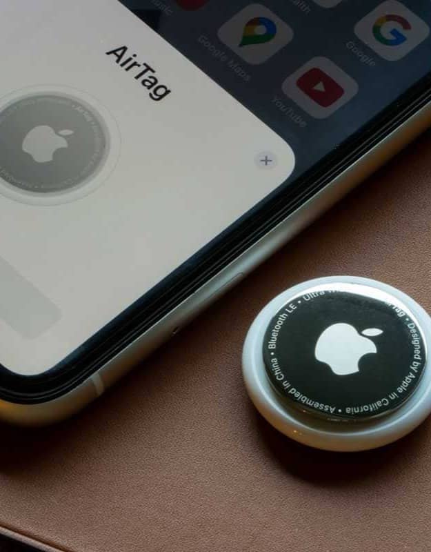 An Apple AirTag sitting next to an iPhone