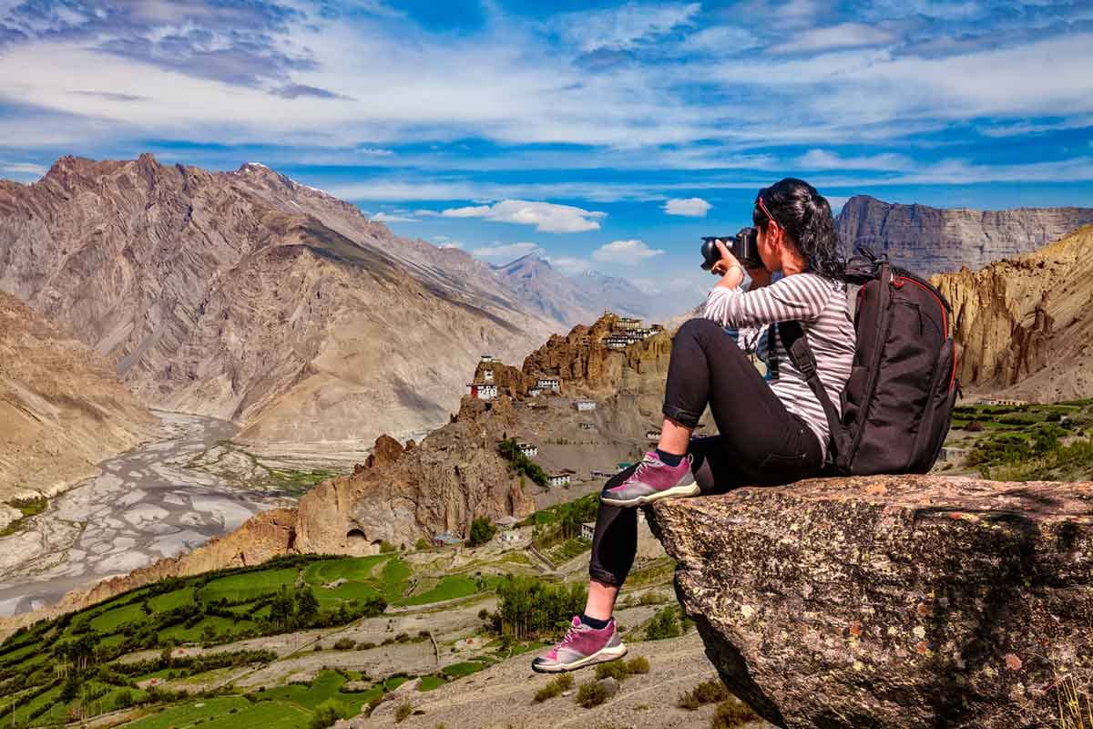 A female tourist takes a photo of the Spiti Valley in Himachal Pradesh, India.