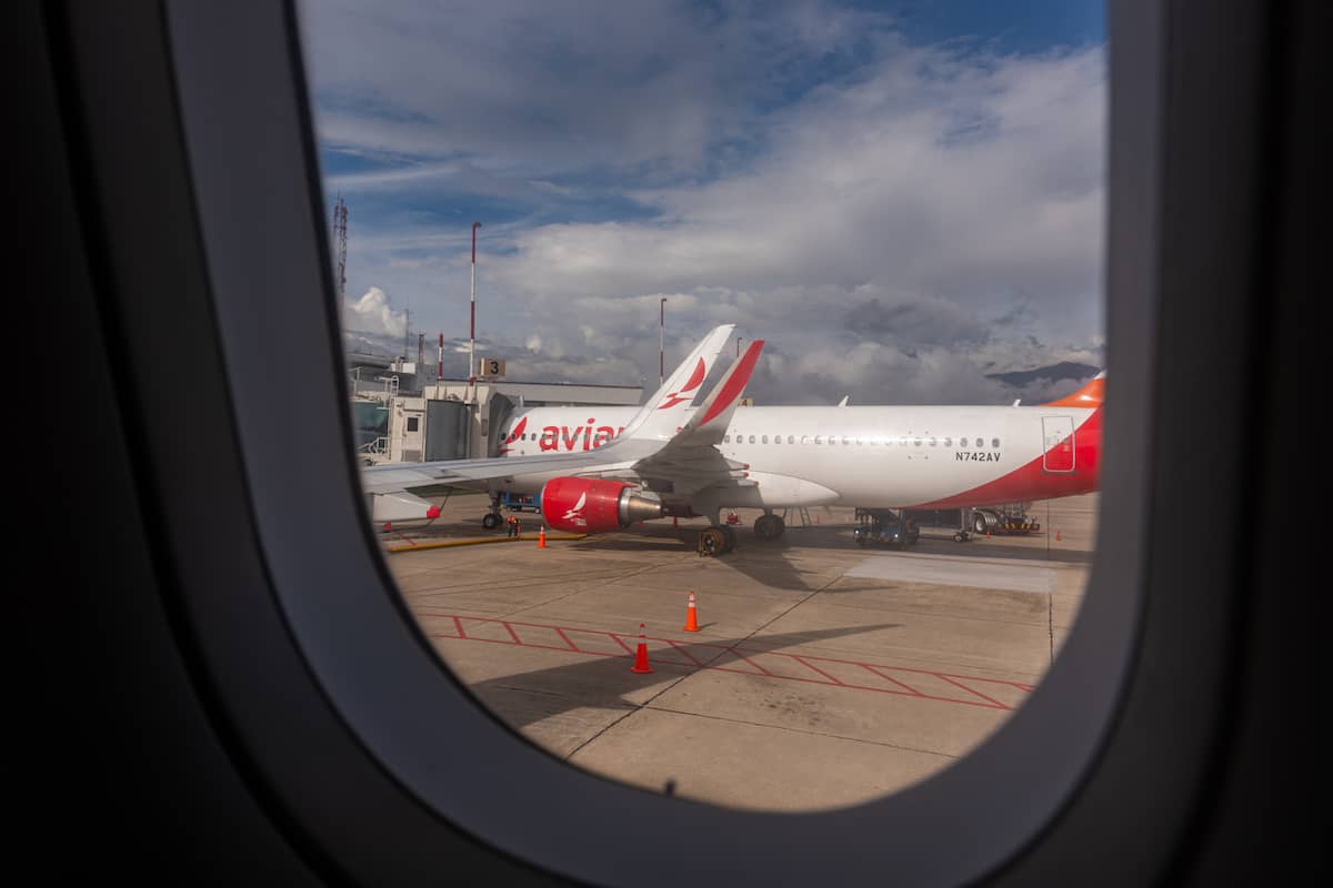Avianca jet at the gate, seen through a plane window
