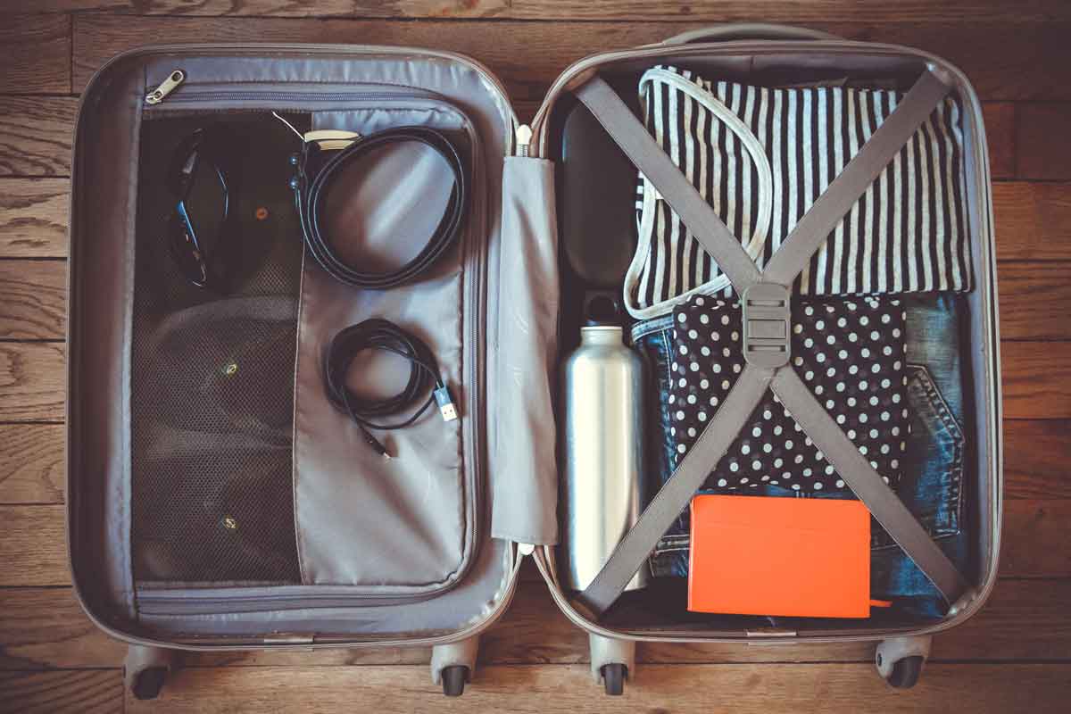 A well-organized suitcase packed with travel gadgets.