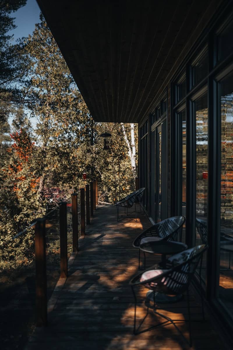Modern balcony overlooking a lush forest setting.