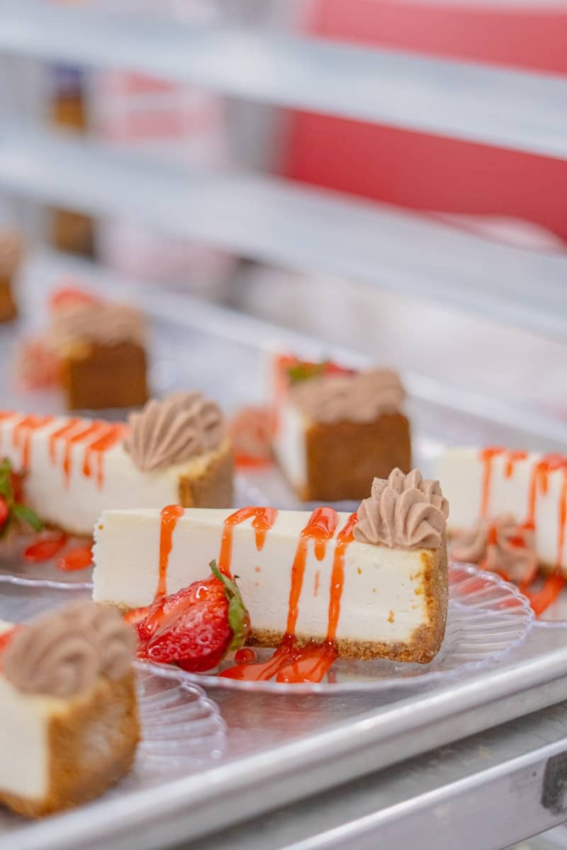 Delicious cheesecake slices with strawberry garnish.