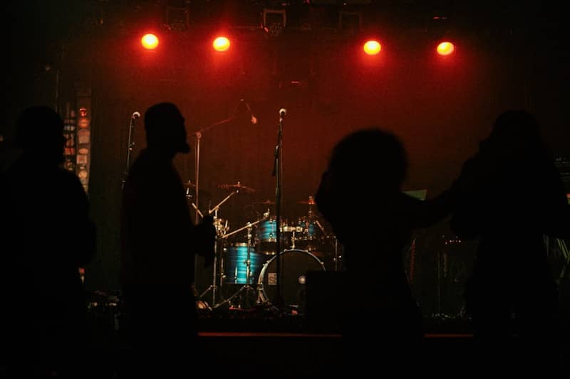 A group of people that are standing in front of a stage