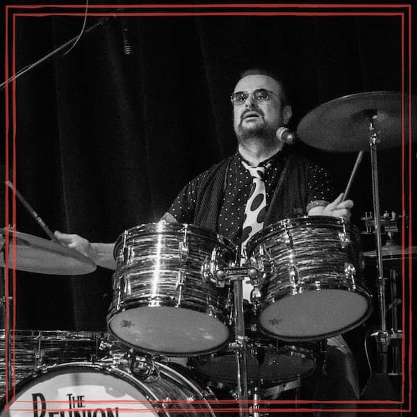 Terry Carleton playing drums at a show for The Reunion, Beatles tribute band.