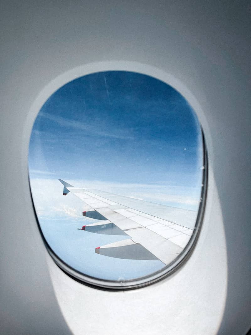 Looking out the airplane window while traveling