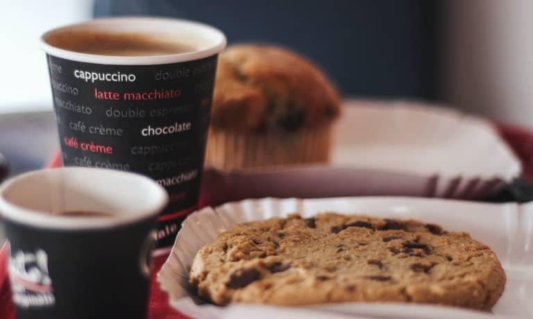 shallow focus photography of cookie and cup of coffee