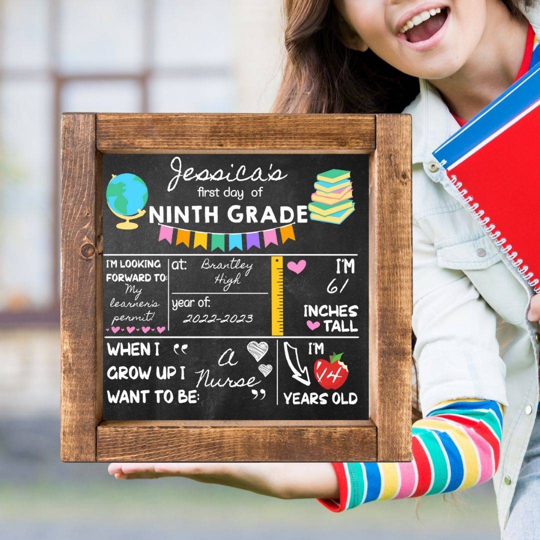 Young girl holds a back to school sign with bright and colorful vinyl. The sign reads her name and what she wants to be when she grows up. 