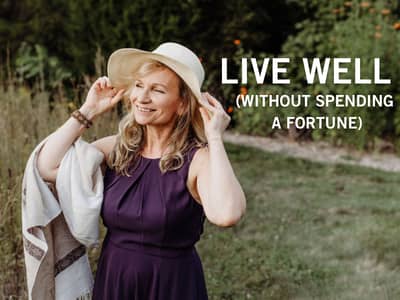 smiling woman gently holding a pretty straw hat on her head