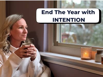 woman gazing out the window with a mug in hand