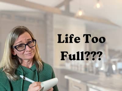 overwhelmed woman with notepad and pen in hand